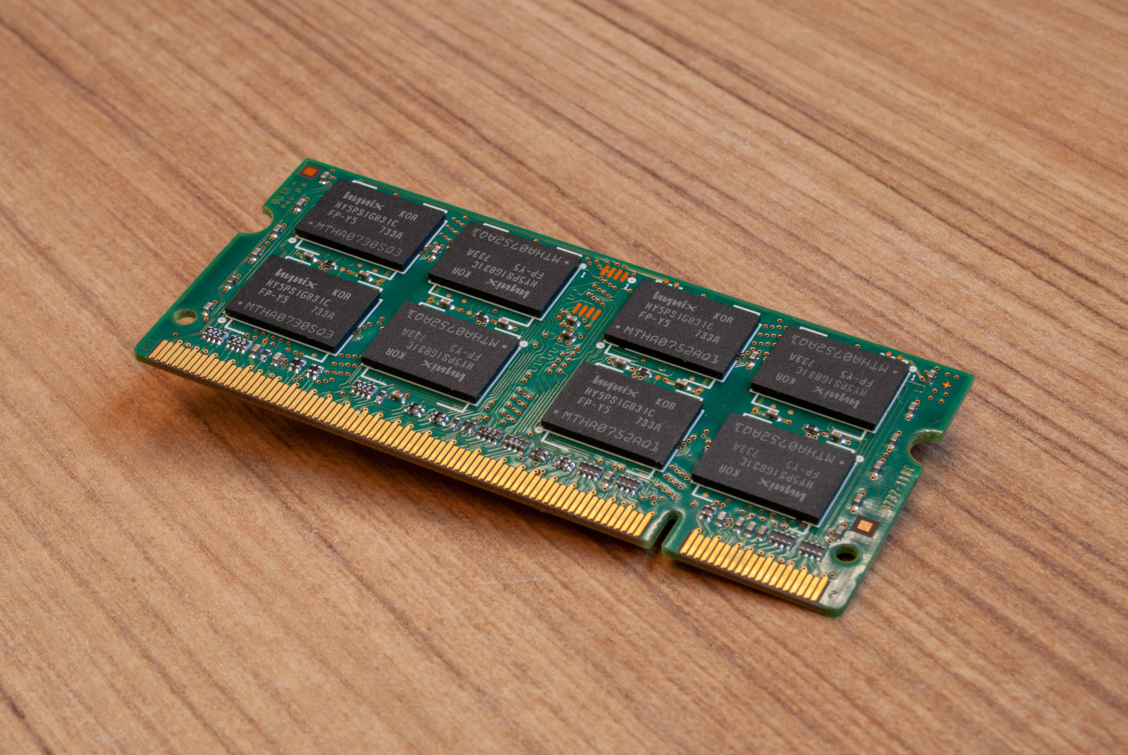 A Hynix SO-DIMM memory module on a wooden surface; illustrative context for Apple memory sourcing.
