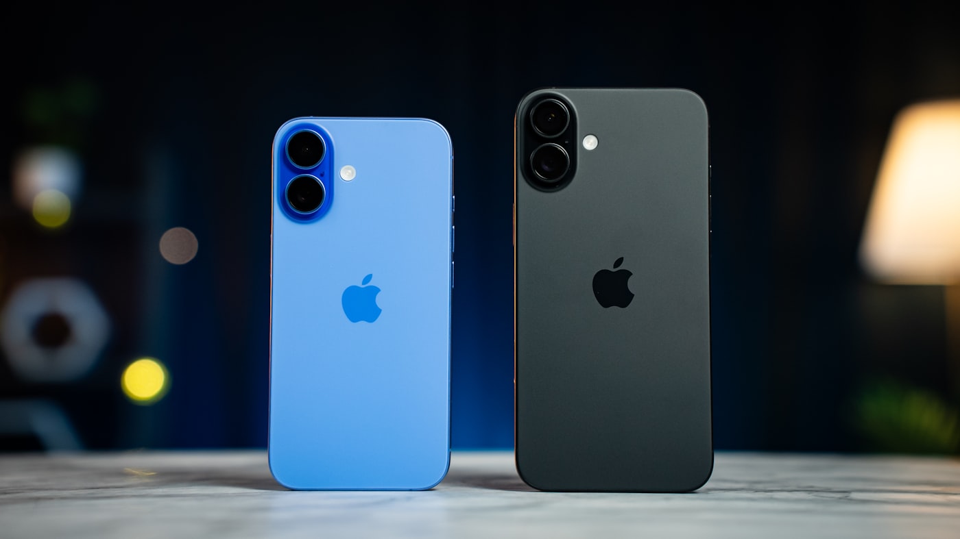 Two standard iPhones standing on a marble surface; Apple has not shown a foldable iPhone and no foldable device appears here.