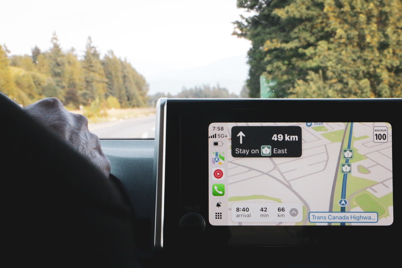 Apple Maps turn-by-turn guidance on a CarPlay screen; this contextual photograph does not show a Maps advertisement