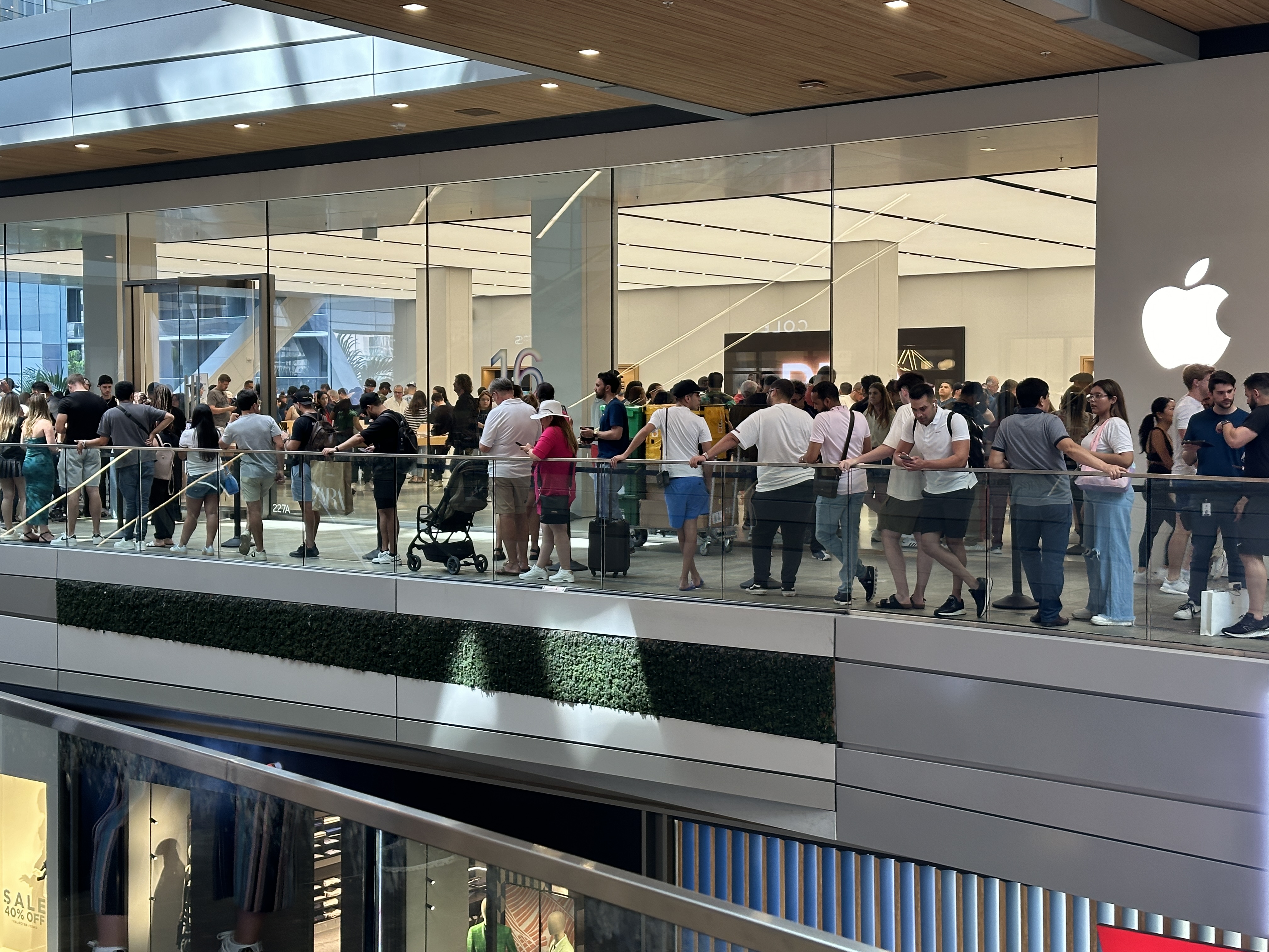 Customers waiting outside the Apple Store at Miami Worldcenter on September 20, 2024