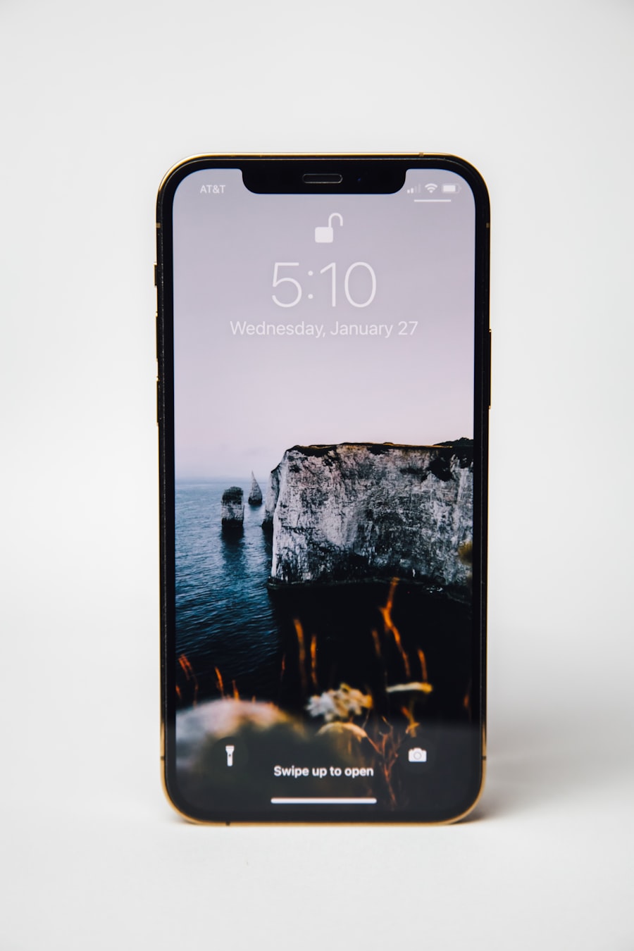 An iPhone on a lock screen with an open padlock icon; contextual photograph, not the iOS 27 Passwords interface.