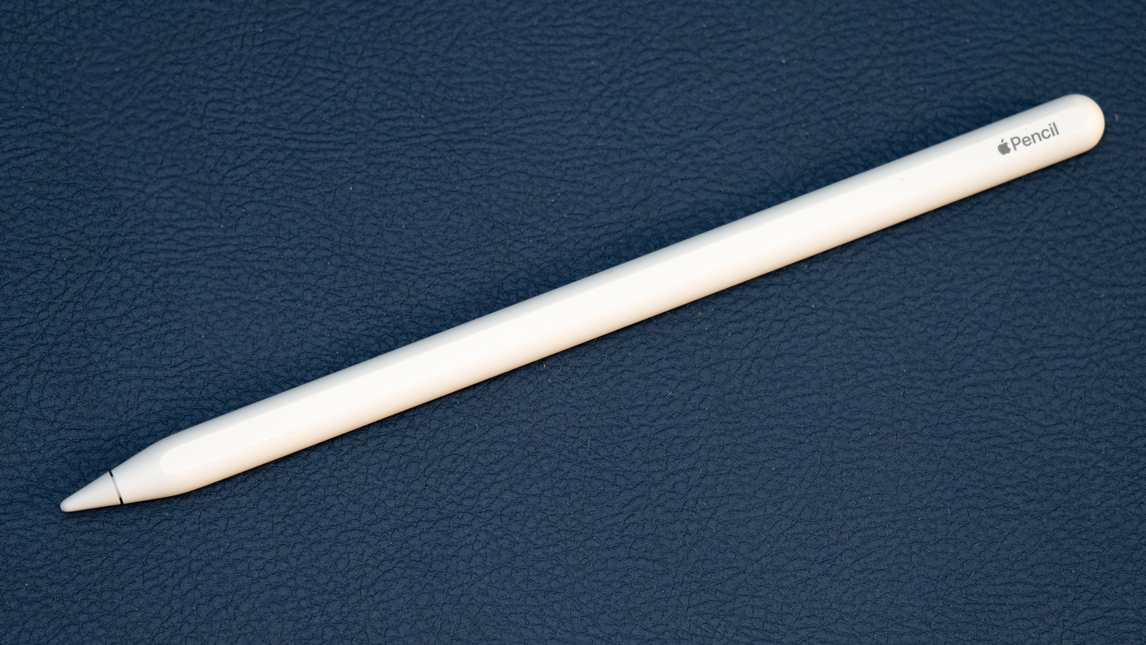 An Apple Pencil for iPad photographed on a dark blue surface; the foldable iPhone prototype was not shown