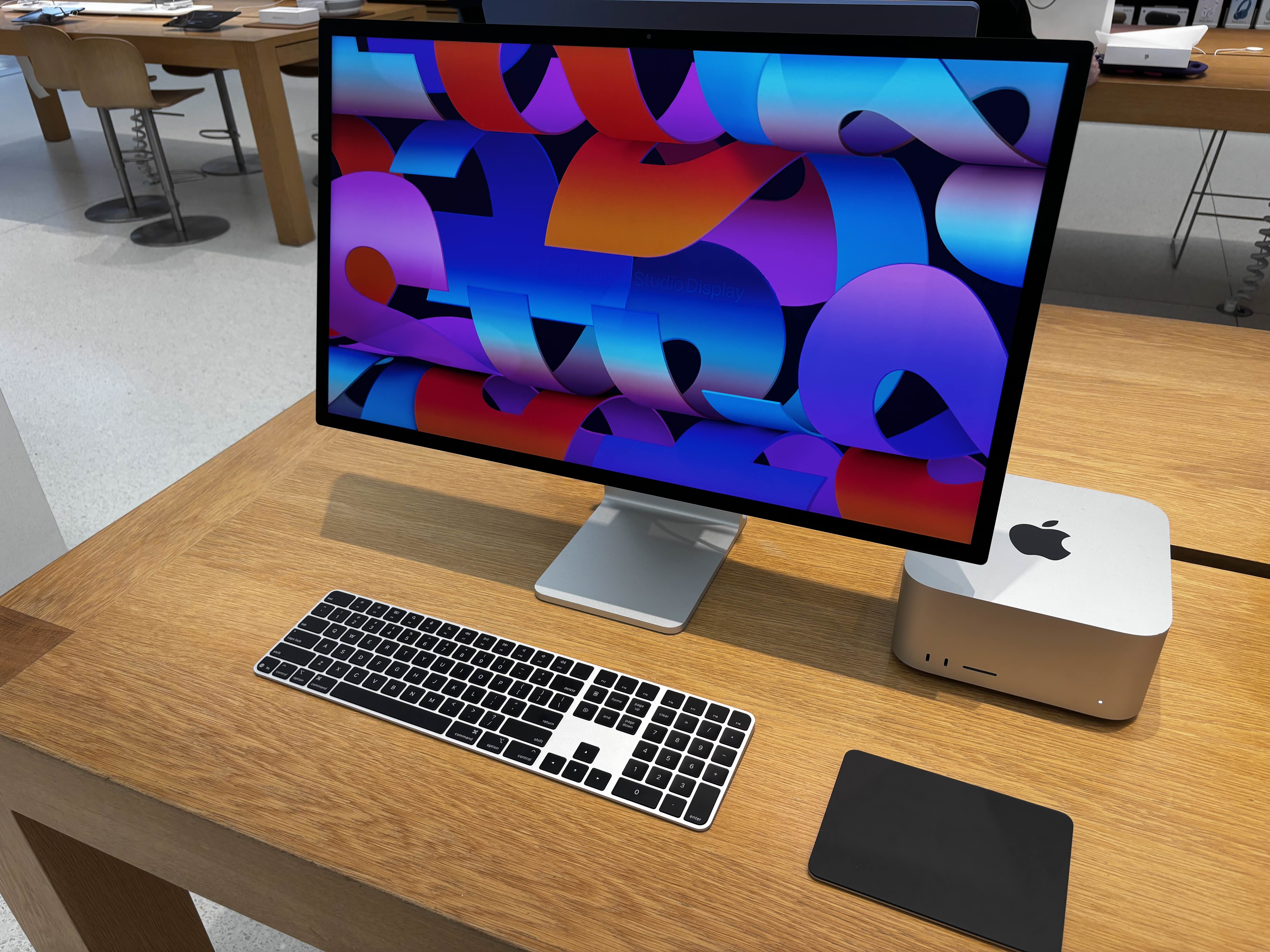 A Mac Studio and Studio Display on a workbench in an Apple Store