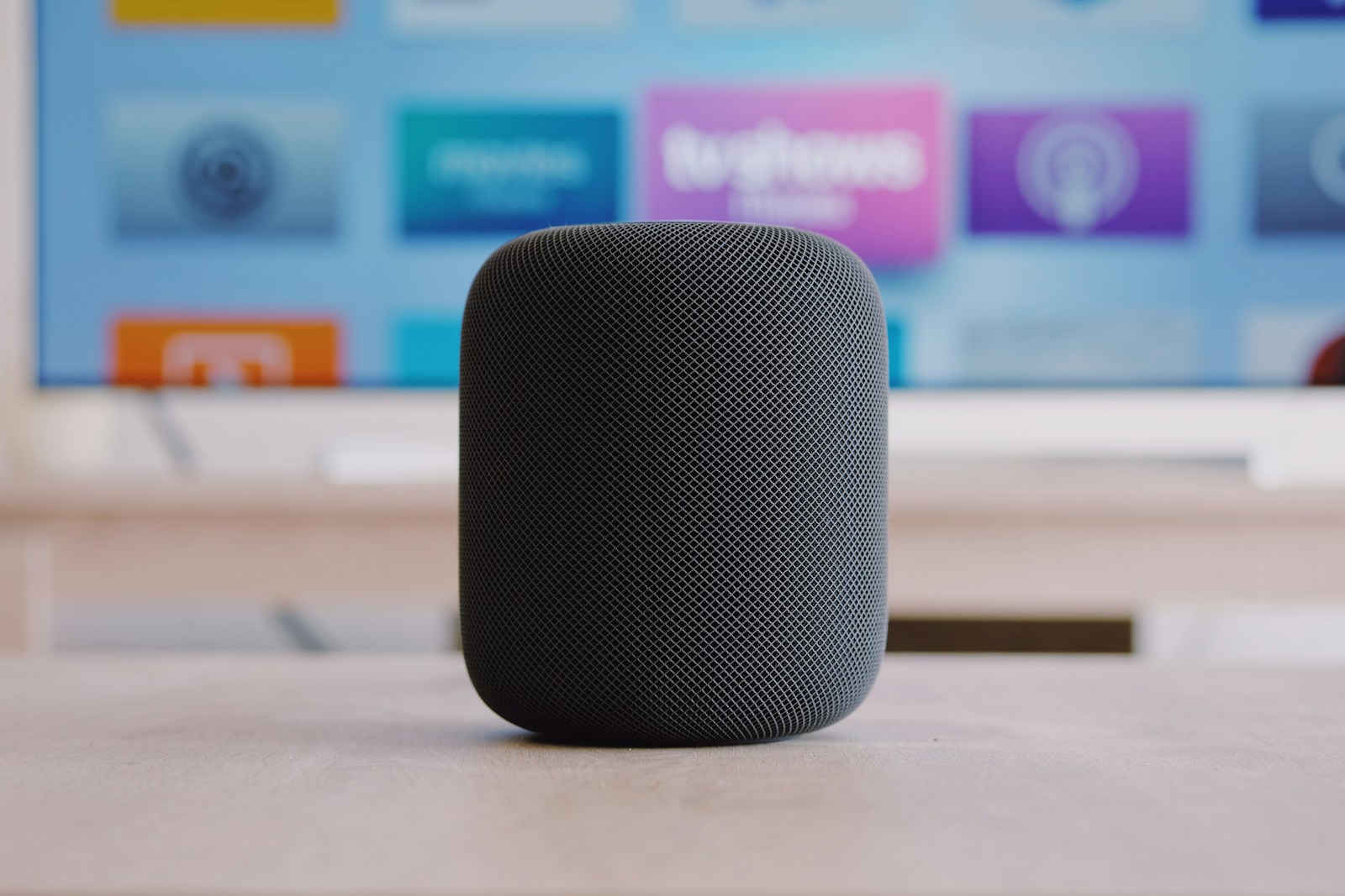 The current black HomePod mini sits on a table; the unreleased colors discussed in this article are not shown.