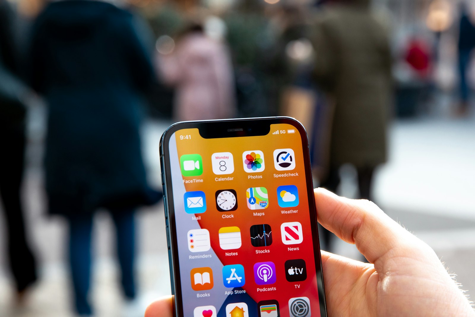 Illustrative photograph of a person holding an iPhone; it does not show an iPhone 18 Pro Max or a service failure.