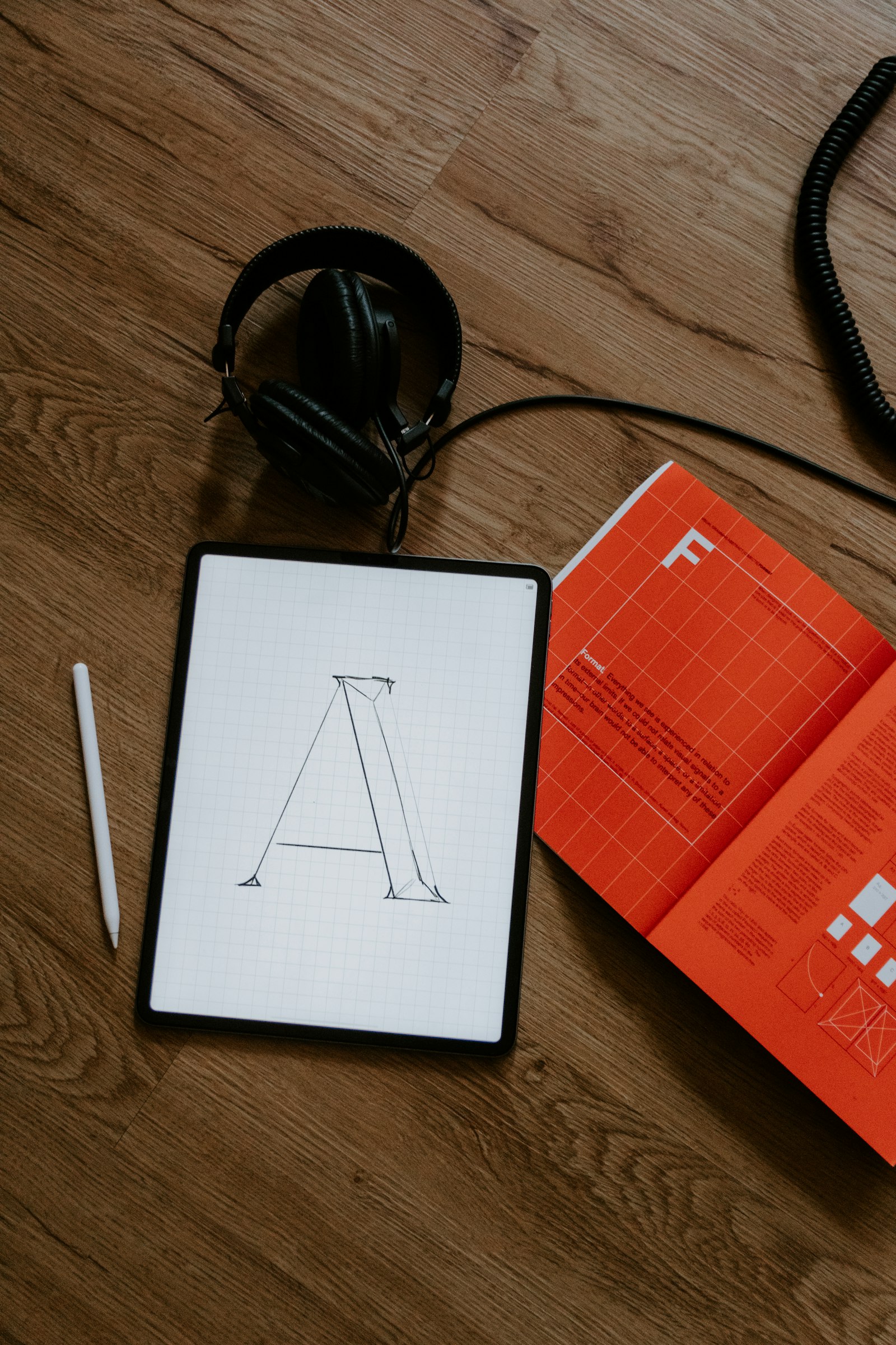 iPad with Apple Pencil on a wooden desk